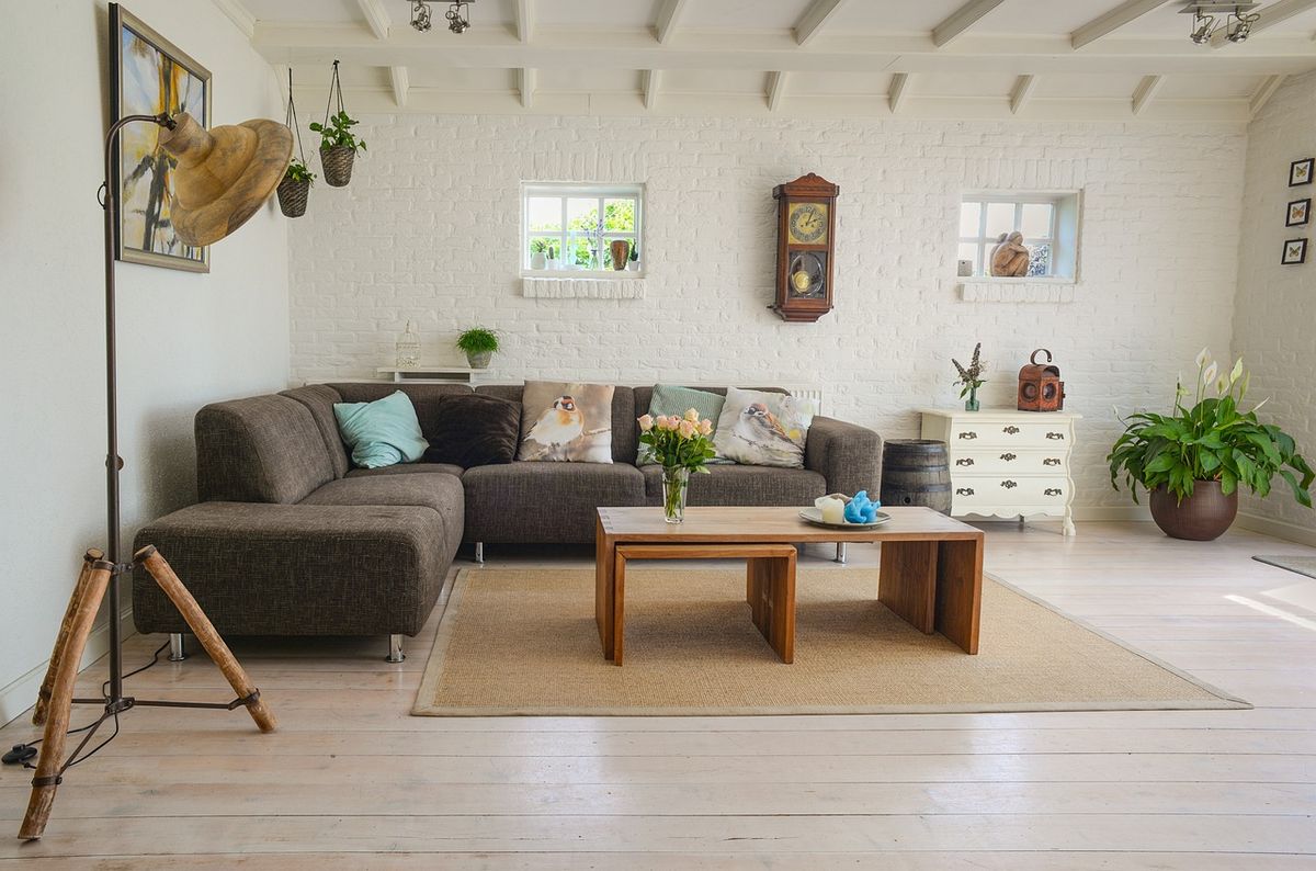 A bright modern living room, the kind of space a HomeKit-compatible camera might monitor