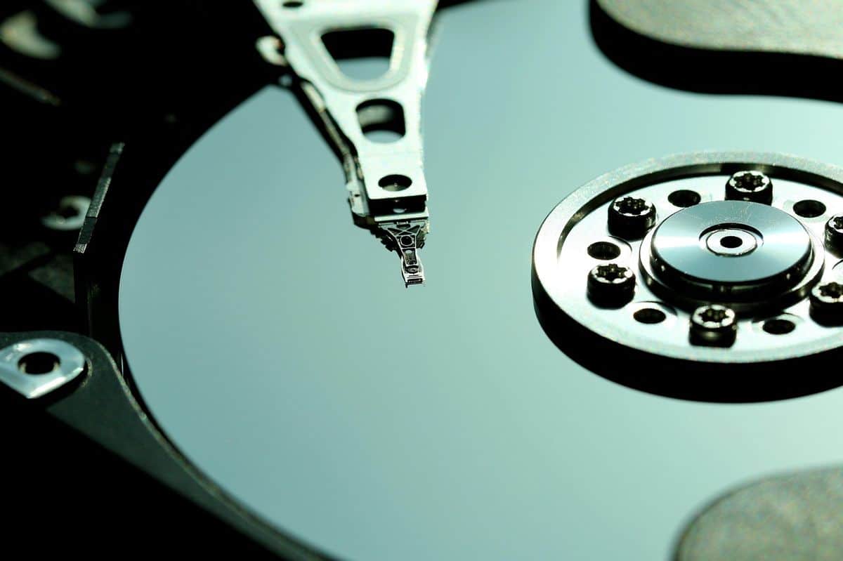 The internals of a mechanical hard drive, representing local storage as an alternative to a cloud subscription