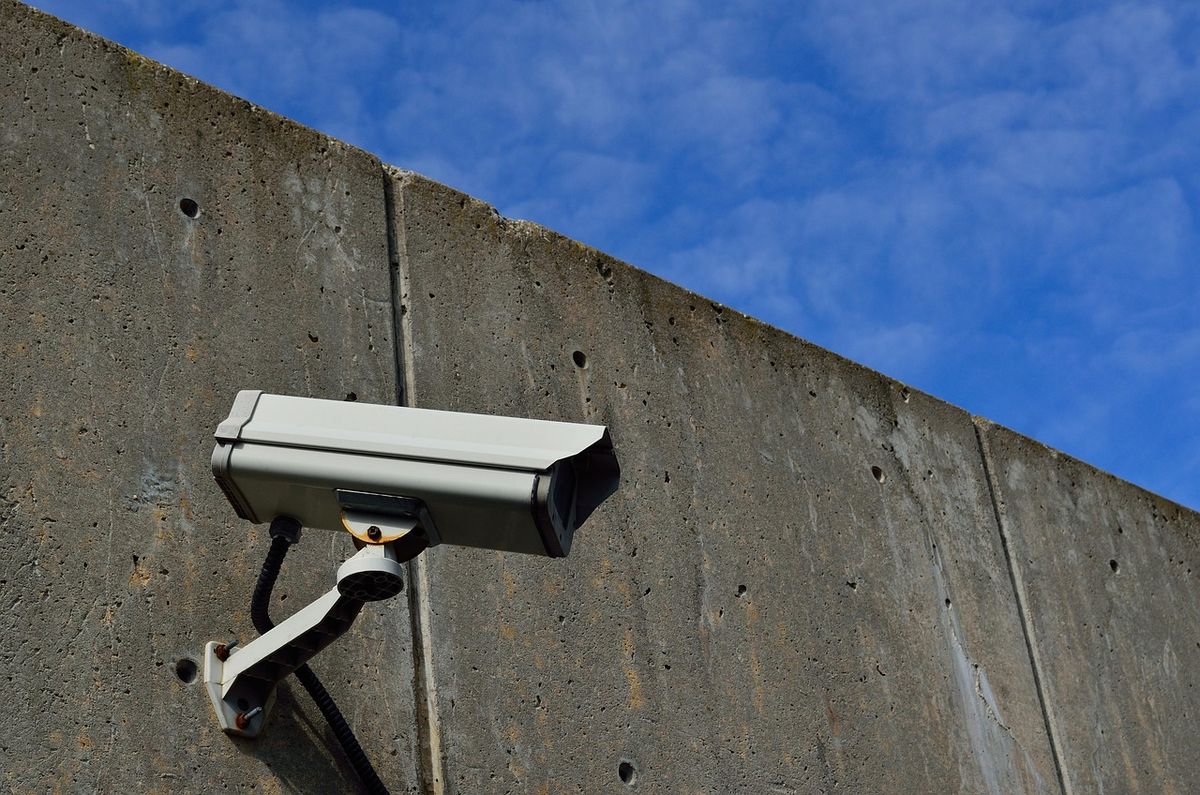 A security camera mounted on an exterior wall