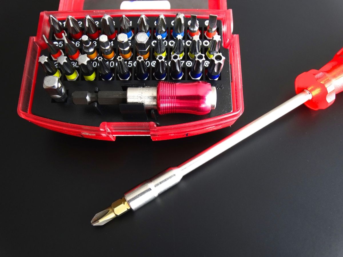 A screwdriver and bit set, similar tools used for small electronics work