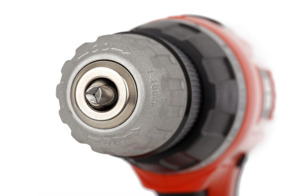 Close-up of a cordless drill chuck, a tool used for deadbolt installation