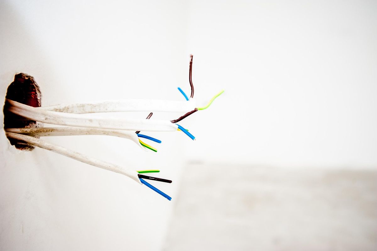 Exposed electrical wires from a wall junction box, the kind of wiring a neutral wire question refers to