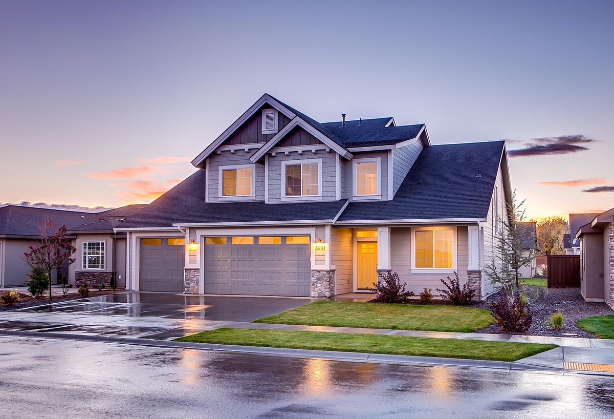 A suburban house exterior with a front door, a typical spot to mount a video doorbell