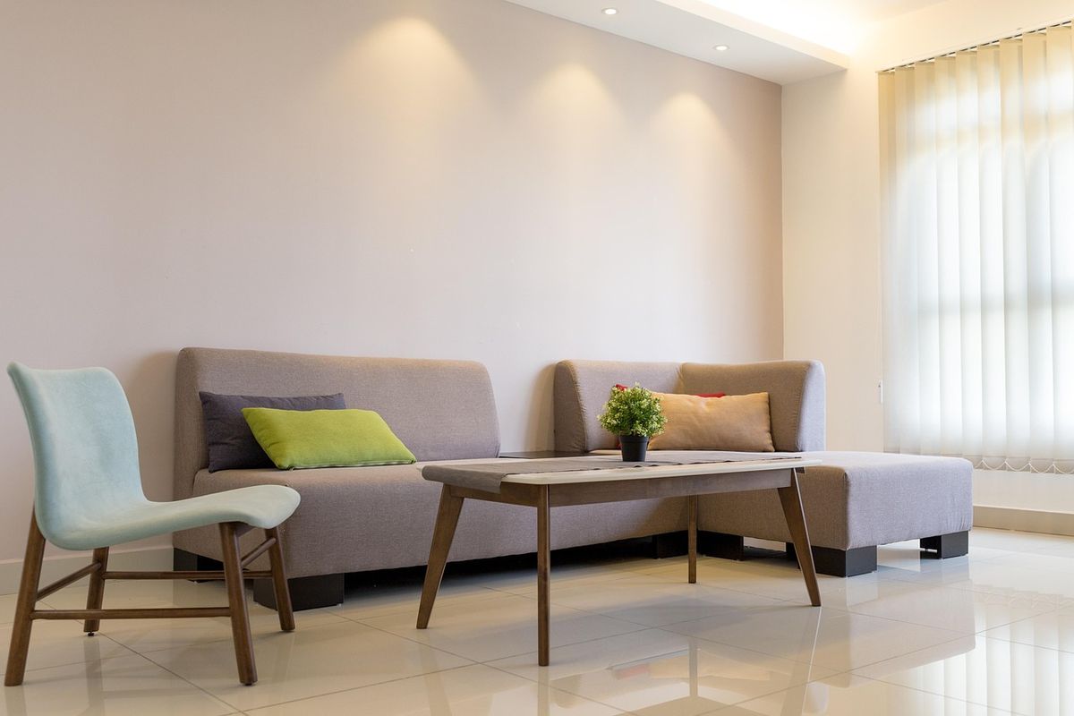 A modern living room with a sofa and coffee table, the kind of space a smart thermostat manages comfort in