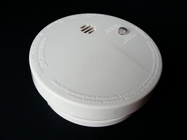 White smoke detector alarm mounted on ceiling