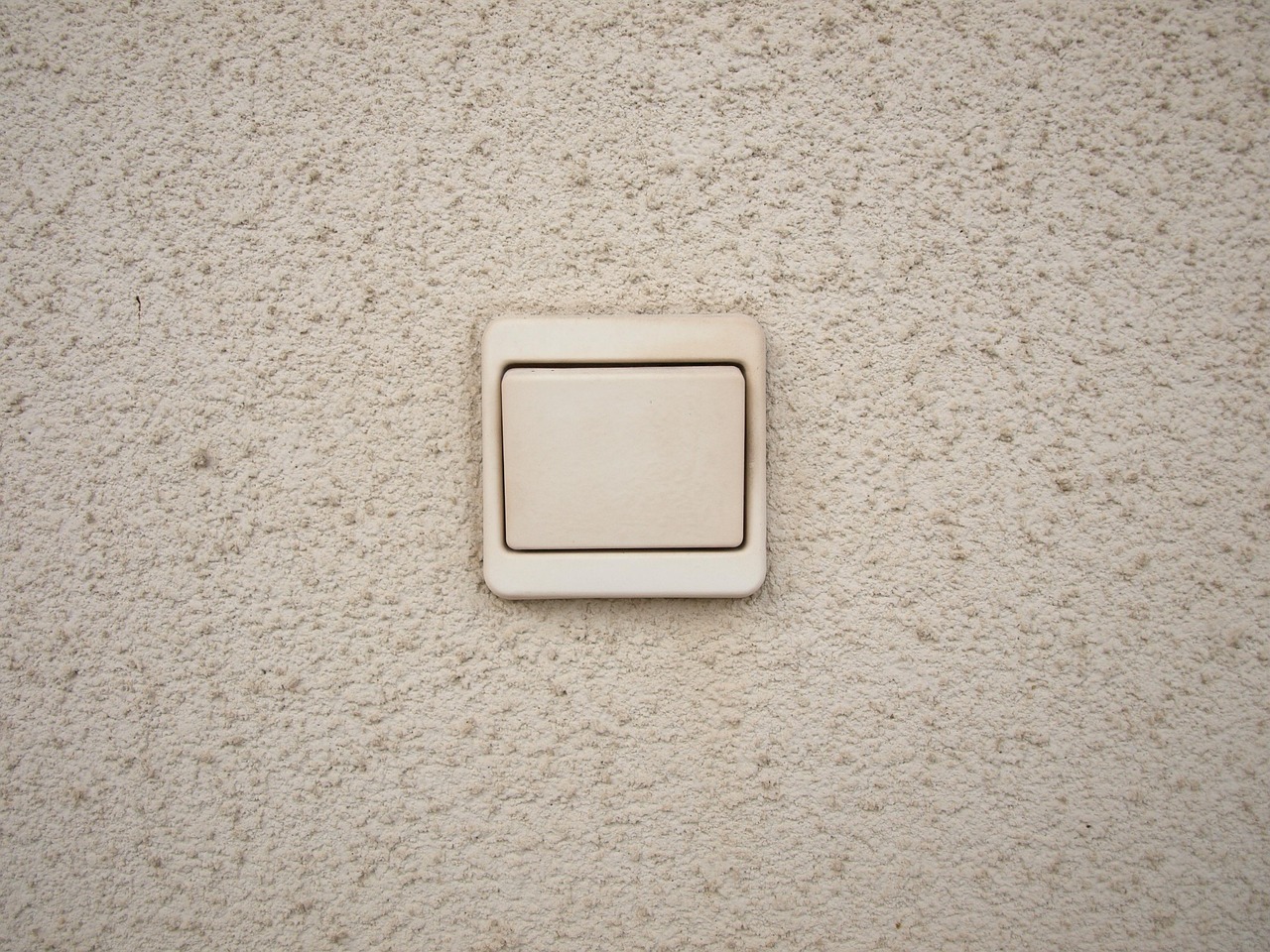 Smart light switch mounted on white wall