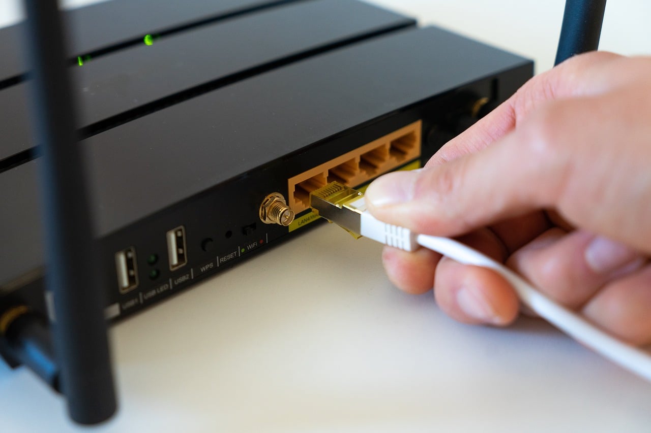 Wireless router hardware with antennas, representing the kind of always-on box a HomeKit bridge runs on