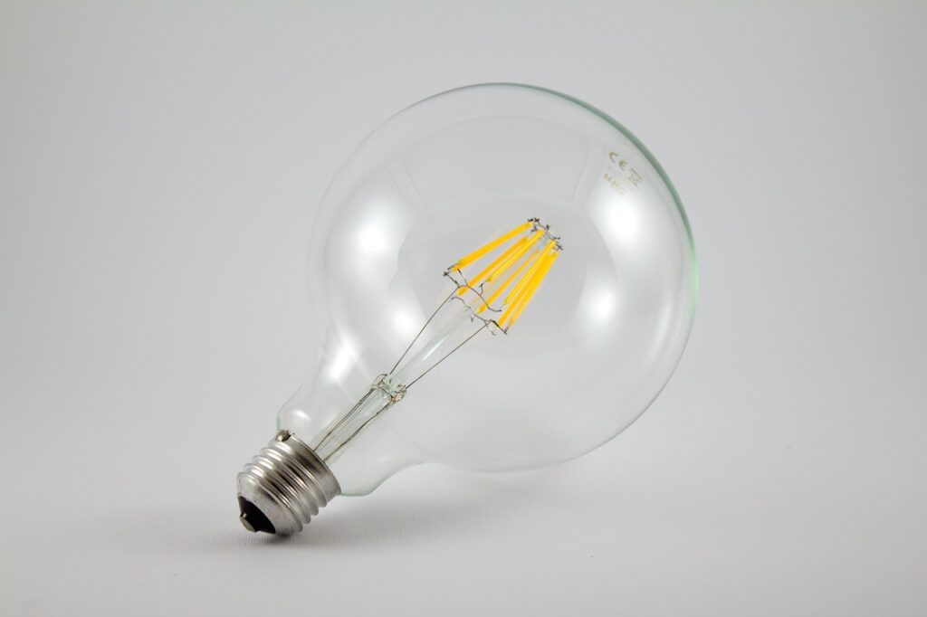 Closeup of LED filament diodes inside a clear smart bulb, showing the chips and driver wiring that determine real-world lifespan